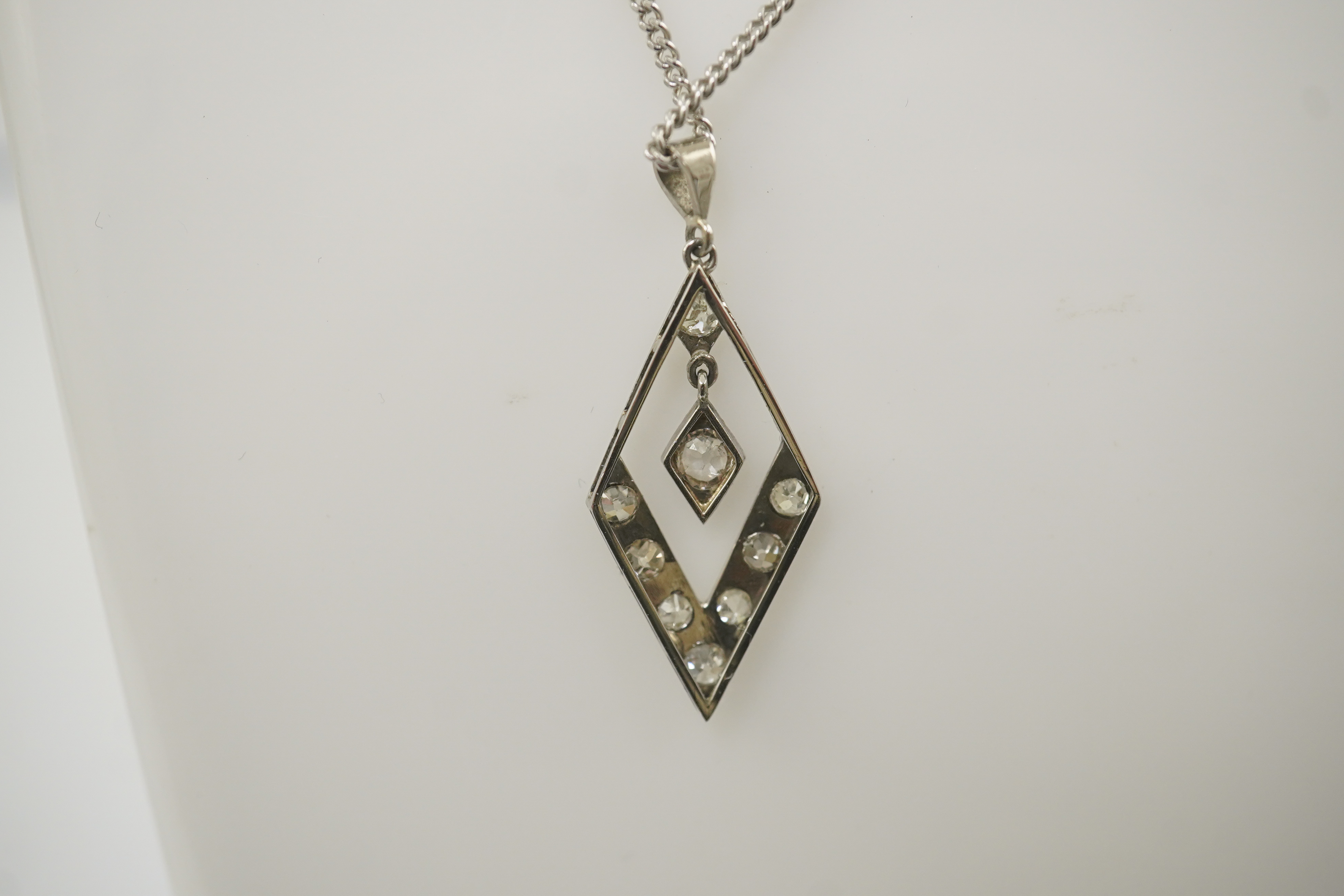 A 1940's white gold? and millegrain set diamond cluster drop pendant